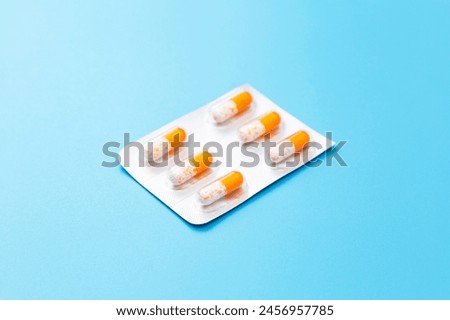 Capsule tablets on a blue background.