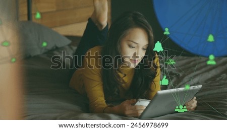 Image of media icons over happy caucasian woman using tablet. social media and communication interface concept digitally generated image.
