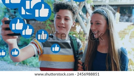 Image of media icons over happy caucasian schoolkids using smartphone. social media and communication interface concept digitally generated image.