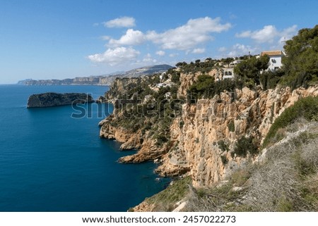 Cap de la Nau, beautiful views of the cliffs and the blue sea of Alicante, on the Gulf of Valencia, Mediterranean Sea, Spain  Royalty-Free Stock Photo #2457022273