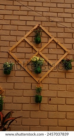  photo showing beauty and uniqueness of Vertical farming.based on the idea of recycling plastic bottles in effective way,using it for vertical farming These little flowers enhancing the beauty of wall