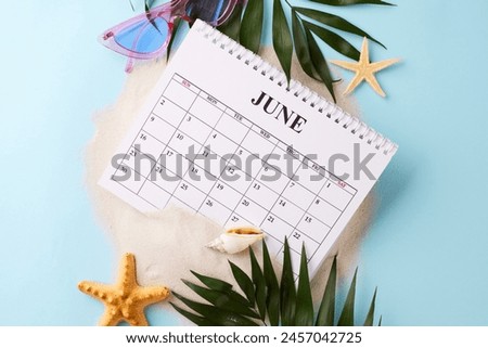 June calendar amidst beach-themed elements, suggesting the perfect time to plan for summer vacations. It is an excellent visual for seasonal marketing campaigns