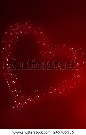 Heart of water drops on a red background. Valentine's Day.