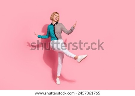 Full size photo of pretty young girl dancing have fun wear trendy striped cyan outfit isolated on pink color background