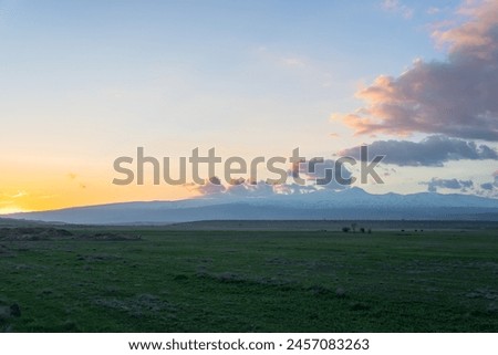 Green fields, mountains, clouds in the sky, natural picture