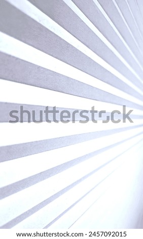 White fabric blinds sunburst pattern. 