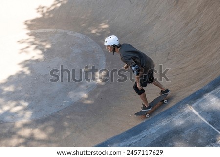 54 year old Brazilian skateboarder having fun at a skate park on a sunny day_17.