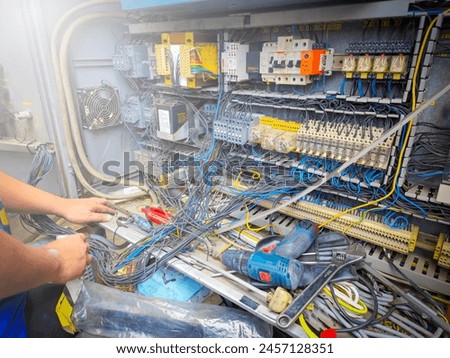 about the electrician doing recondition electrical systems there are magnetic, relay, wiring cable, breaker, overload protection, missy Royalty-Free Stock Photo #2457128351
