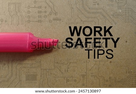Word text Work Safety Tips memo written on a brown craft paper as background with red highlighter pen