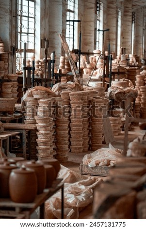 Neatly stacked clay embryos and molds in a traditional Chinese pottery factory