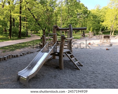 Wooden modern ecological safety children outdoor playground equipment in public park. Nature architecture construction playhouse. Rest and childhood concept. Idea for games on air