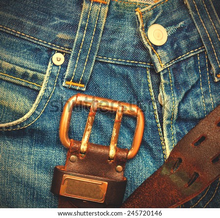 part of a vintage jeans with old leather belt 