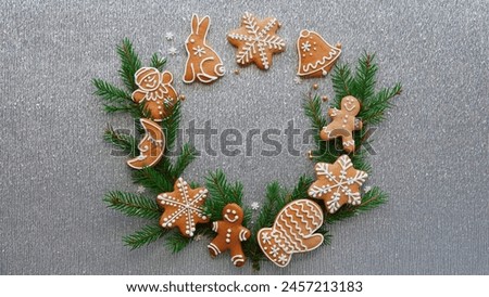A Holiday Invitation: Gingerbread Cookies and Pine on Sparkling Backdrop. Arrangement of Christmas Decorations for a Seasonal Greeting