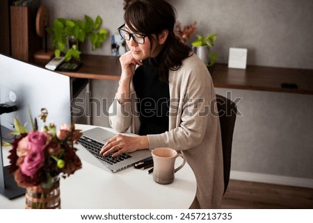 A woman relaxing and looking at a laptop