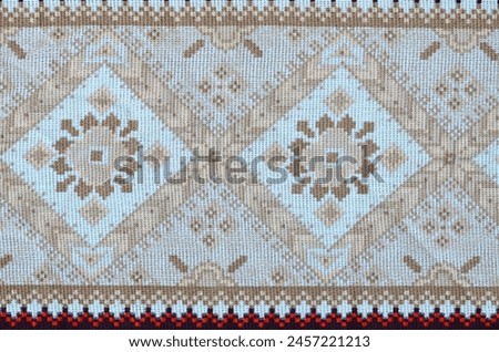 Traditional Ukrainian folk art knitted embroidery pattern on textile fabric. Colored pixel design knitted canvas.