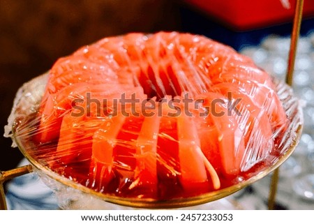 Strawberry-flavored pudding sliced and arranged in a container, ready to be served.