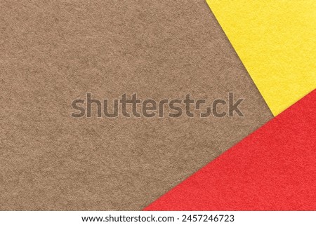 Texture of craft brown color paper background with yellow and red border. Vintage abstract umber cardboard. Presentation template and mockup with copy space. Felt backdrop closeup.