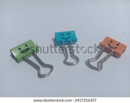 Binder paper clips emoticon smiley on a white background 