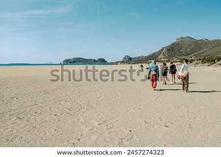 Falassarna Beach, Phalasarna beach in Crete. Beautiful long sandy beach in western Crete. Friends walking on the beach. Greece.  Royalty-Free Stock Photo #2457274323