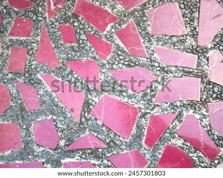 Various shape of red ceramics on a concrete pathway 