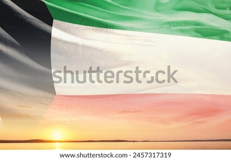 Kuwait national flag waving in the sky.