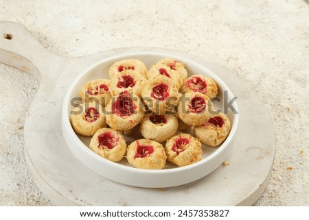 Homemade thumb print cookies or Hallongrottor or Swedish rapsberry caves jam cookies,filled with strawberry jam and grated cheese