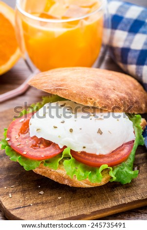 Burger with pouched egg and tomato