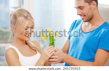 bright picture of happy romantic couple with flowers, focus on woman