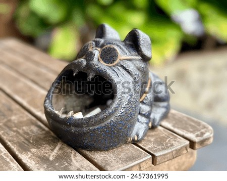 A very unique dog-shaped stone cigarette ashtray. Jakarta May 1, 2024