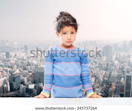 people, childhood and emotions concept - sad little girl over city background