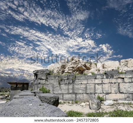 Roman ruins at Umm Qais (Umm Qays)--is a town in northern Jordan near the site of the ancient town of Gadara, Jordan. Against the background of a beautiful sky with clouds 