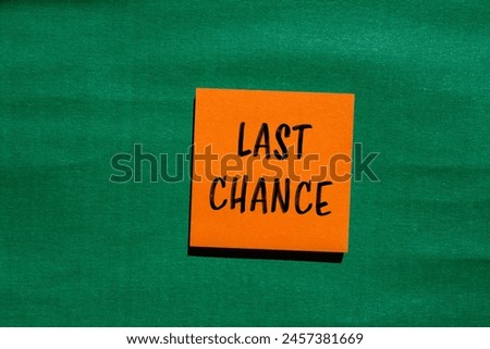 Last chance words written on orange paper sticker with green background. Conceptual last chance symbol. Copy space.
