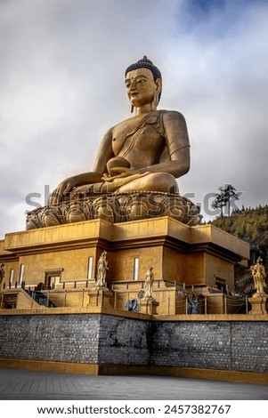 Three quarter view of the iconic Buddha Statue at Thimphu, Bhutan. Buddha Dordenma Statue. It is a popular belief in Bhutan that Lord Buddha looks after the city of Thimphu from his hill top abode. Royalty-Free Stock Photo #2457382767