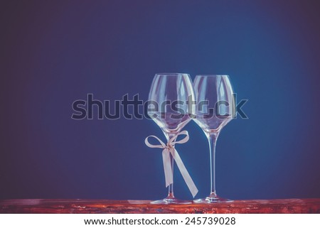 Two wine glasses om blue background. Toned picture