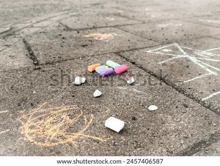 Photos of drawings drawn by children with chalk on the street. The picture is drawn with multi-colored chalk on the asphalt on a sunny summer day. Creative development of children.