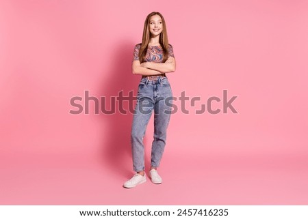 Full length photo of positive girl wear print t-shirt holding arms folded look at sale empty space isolated on pink color background