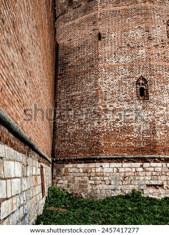 Several loopholes in the 12-coal observation tower of the fortress of the early 17th century Royalty-Free Stock Photo #2457417277