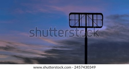 Looking up at a an empty commercial sign frame with a beautiful blurred partially cloudy sunset or sunrise. Copy space.