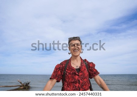 a happy and modern woman jumping on a unique . Real people in summer Royalty-Free Stock Photo #2457440331