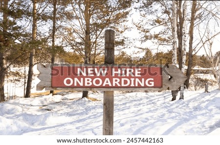 New hire onboarding symbol. Concept words New hire onboarding on beautiful wooden road sign. Beautiful forest snow blue sky background. Business new hire onboarding concept. Copy space.