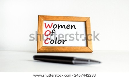 WOC women of color symbol. Concept words WOC women of color on beautiful wooden frame. Beautiful white background. Business WOC women of color social issues concept. Copy space. Royalty-Free Stock Photo #2457442233