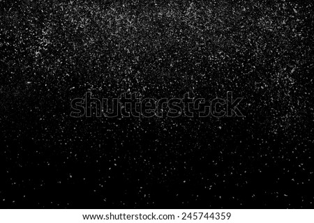 Freeze motion of white powder coming down, isolated on black, dark background. Abstract design of falling dust cloud. Particles cloud screen saver, wallpaper with copy space. Rain, snow fall concept Royalty-Free Stock Photo #245744359
