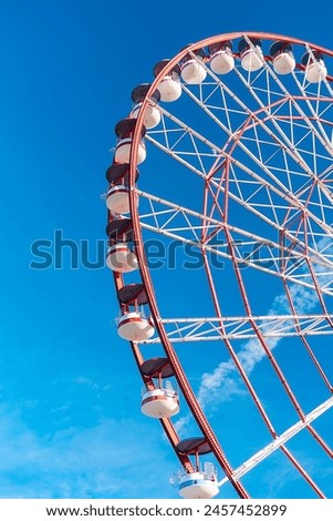 View of the Ferris wheel attraction against a background of blue sky. Ferris wheel in the Georgian city of Batumi.