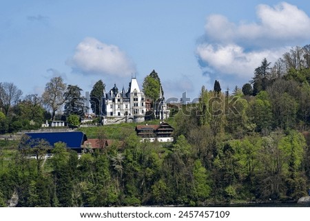 Looking up hill with Meggenhorn Castle with chapel on a sunny spring day. Photo taken April 11th, 2024, Meggen, Canton Lucerne, Switzerland.
