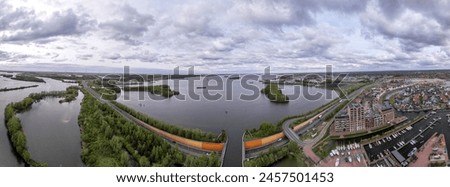 Panorama 180 degrees of Veluwemeer aerial seen from Harderwijk recreational port with highway passing in the foreground