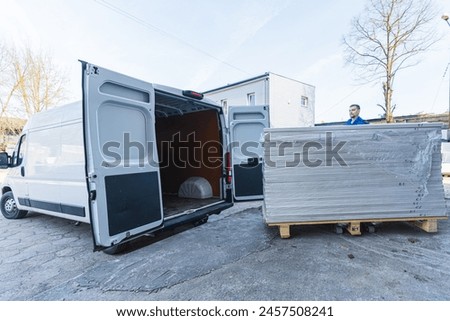 loading the van with wooden things at the carpentry. High quality photo