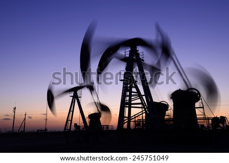 Is operation of the pumping unit in oil field in the evening, close-up  