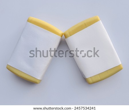 Yellow soap with blank label with color on gray background