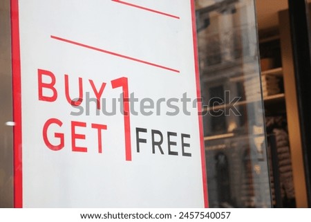 Large Sale text letters on white background on clothing store .