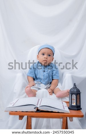 A Muslim baby is learning to read the holy quran